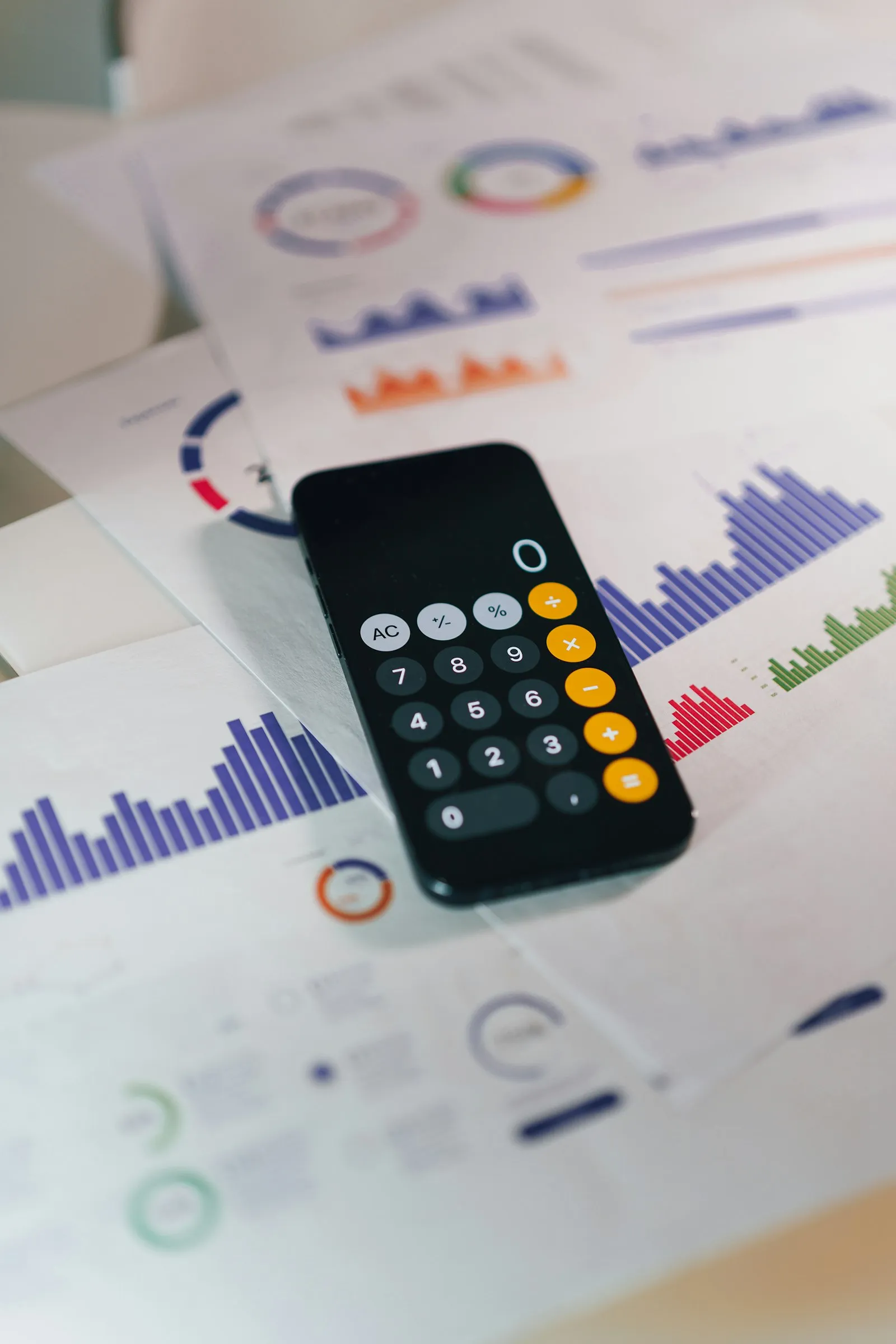 Calculator on printed financial charts