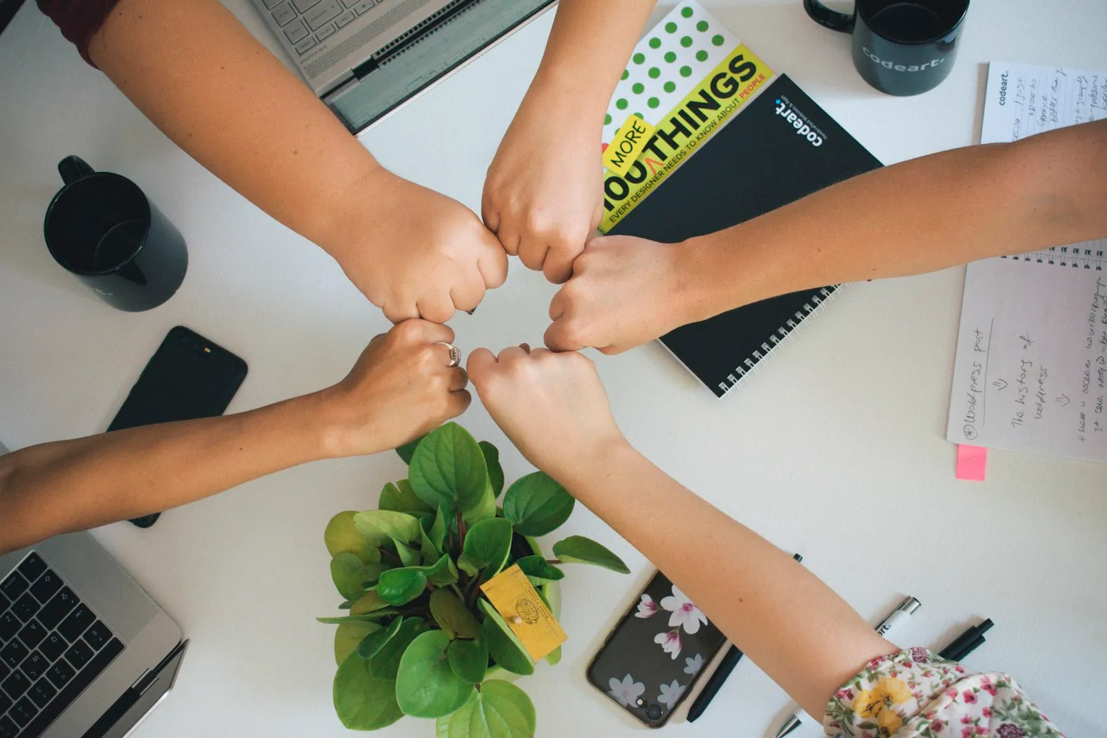 Team joining hands in agreement